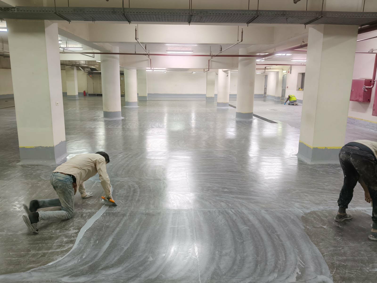Basement level with finished epoxy floor along columns